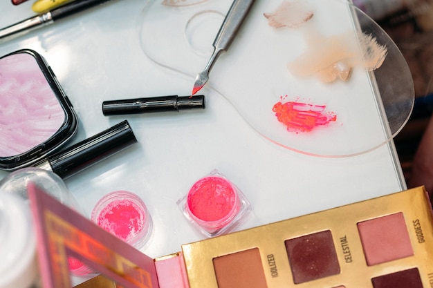 Makeup brushes are in a drawer at the makeup artist's workplace closeup