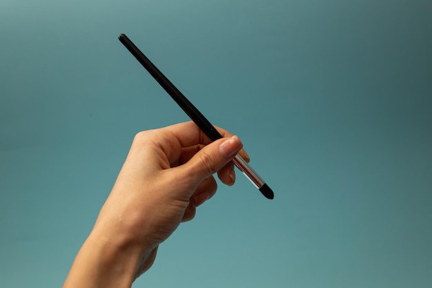 Makeup brushes on a blue background