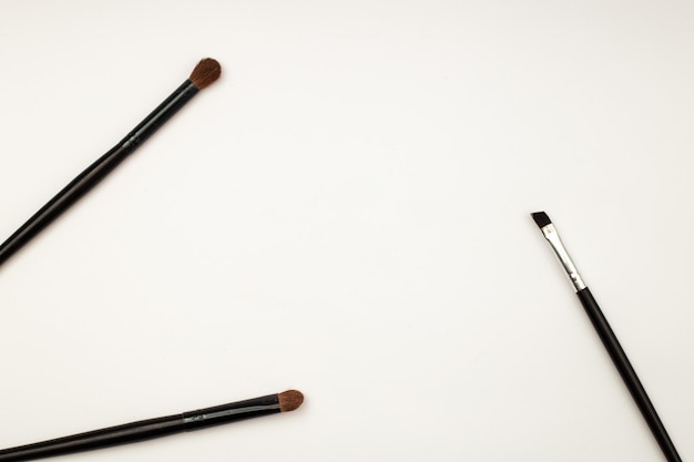 Makeup brushes on white background template frame