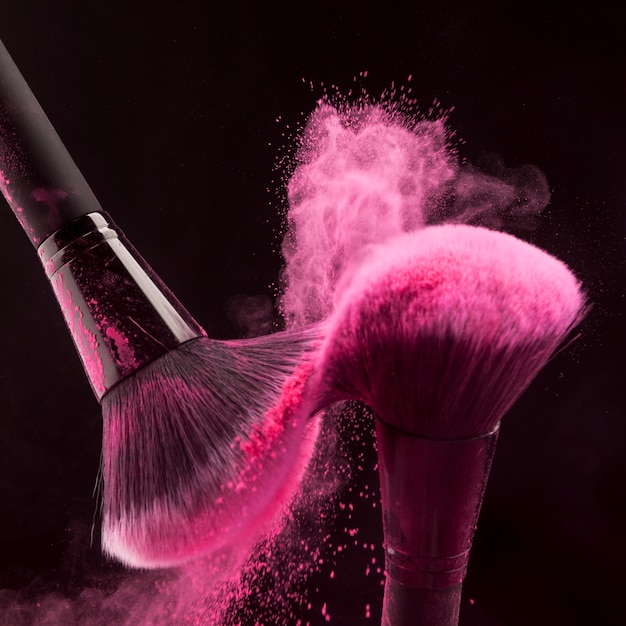 Makeup brushes with pink powder haze