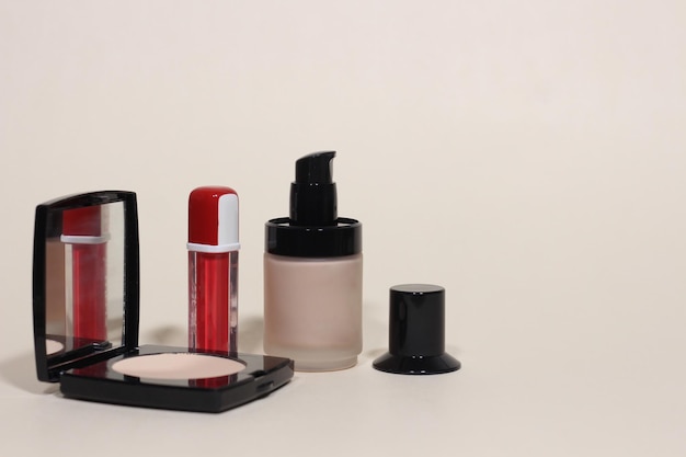 Makeup cosmetic products on beige background