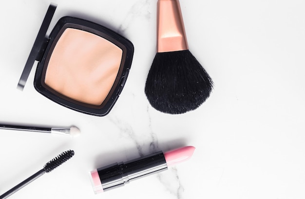 Makeup and cosmetics flatlay on marble