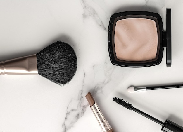 Makeup and cosmetics products on marble flatlay background