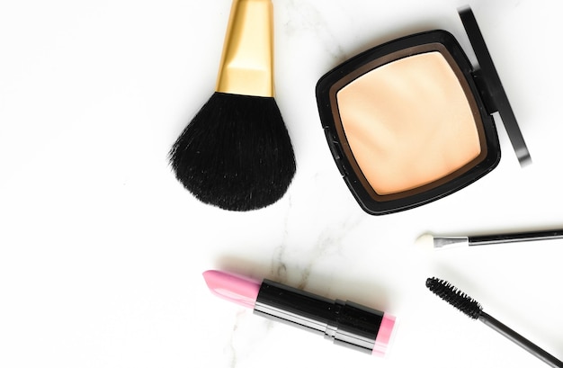 Makeup and cosmetics products on marble flatlay background