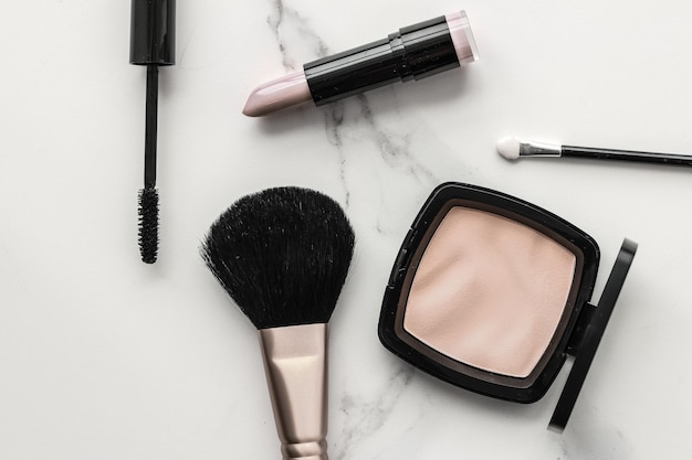 Makeup and cosmetics products on marble flatlay background