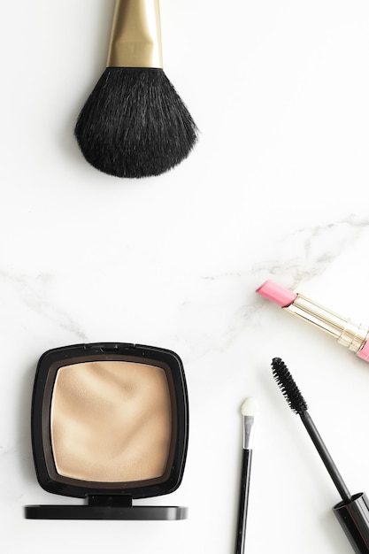 Makeup and cosmetics products on marble flatlay background