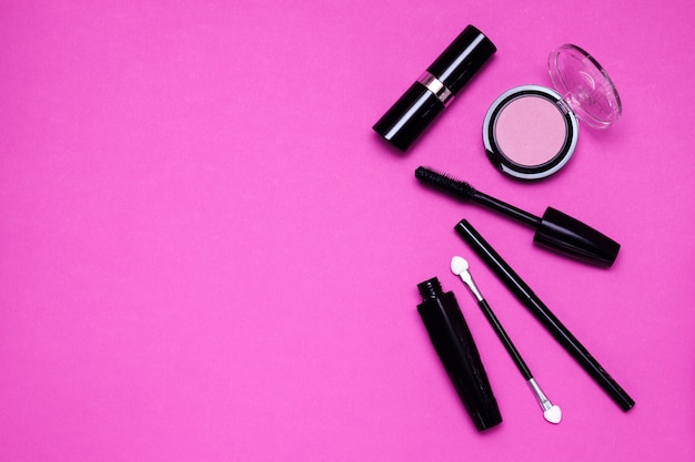 Makeup tools on a purple background.