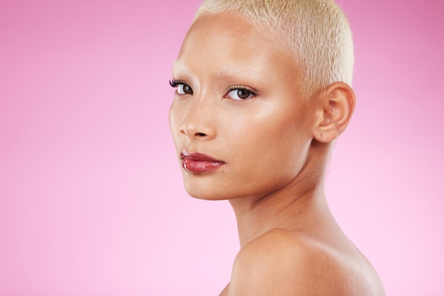 Makeup trendy and portrait of a woman with cosmetics isolated on a pink background in studio Beauty retro and face of a cool vintage model with edgy stylish and classy glamour on a backdrop