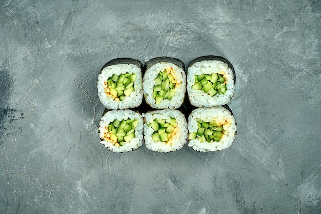 Maki sushi roll with cucumber on a gray background Selective Focus Sushi Menu