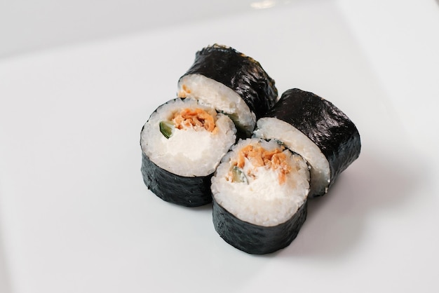 Maki sushi roll with salmon on white plate