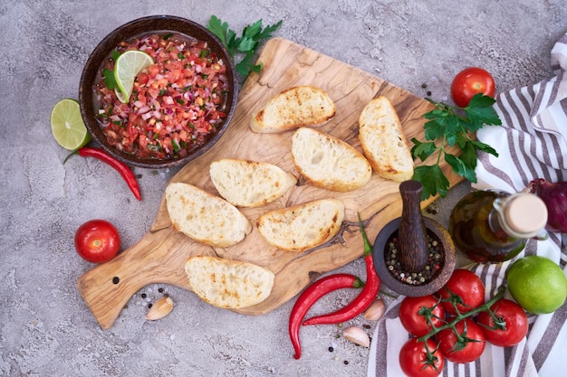 Making bruschetta with freshly made salsa dip sauce