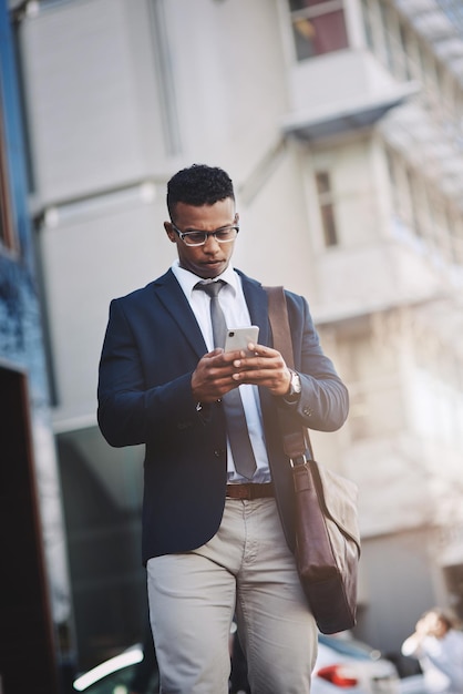 Making business moves straight from his device Shot of a handsome young businessman using a cellphone in the city