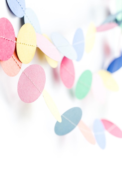 Making a colorful paper garland with reound puncher.