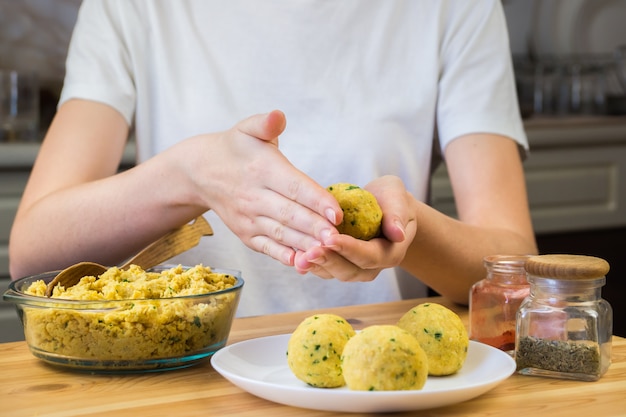 Making falafel balls out of minced chick-peas