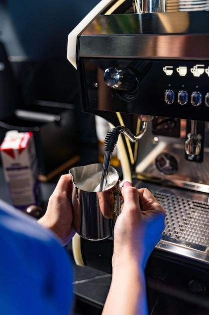 Making fresh coffee Process of making espresso in a coffee machine Woman takes the cup of hot coffee