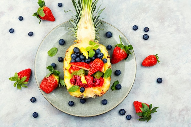 Making fruit salad in pineapple