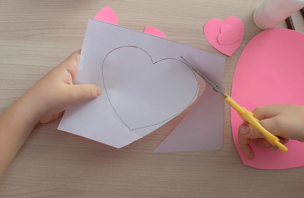 Making handmade Valentine greeting card. Children's craft, hobby concept, gift with your own hands. Decoration for Valentine's Day, Mother's Day. Step 1. Selective Focus.