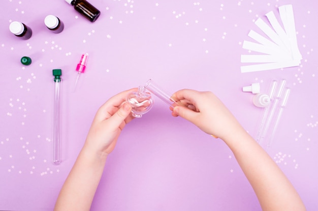 Making perfumes at home. Children's hands make perfume