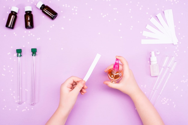 Making perfumes at home. Children's hands make perfume