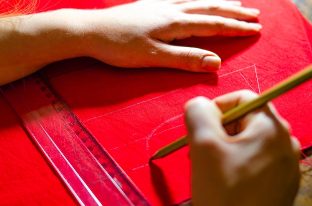 Making a red dress. Tailor dresses. Marking dresses from the finished product. Drawing of a red dress. Create baby red dress