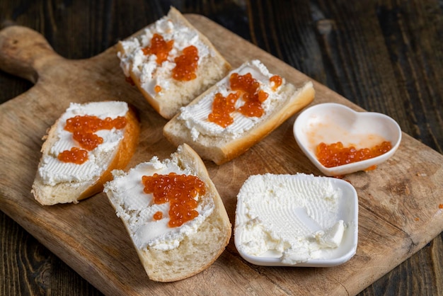 Making sandwiches with baguette and cream cheese with caviar