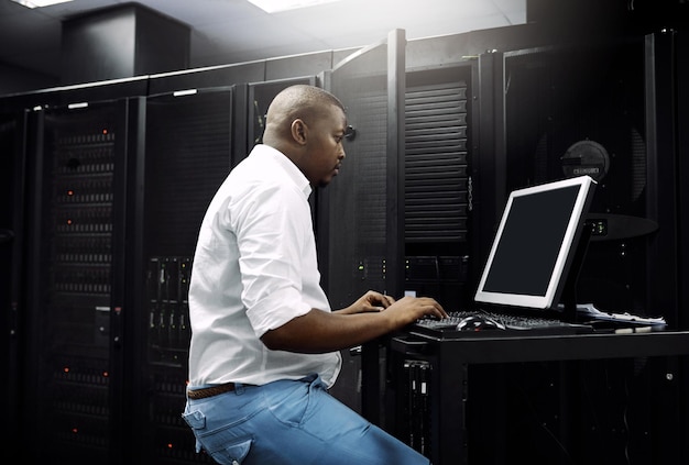 Making sure your servers are protected Cropped shot of an IT technician using a computer while working in the server room of a data center