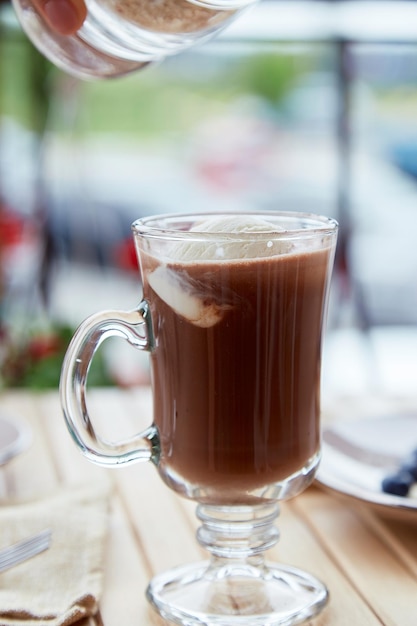 Making of sweet belgian chocolate with ice cream in glass on the terrace cafe Delicious breakfast