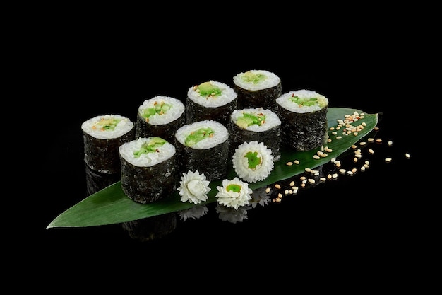 Makizushi rolls with avocado and cucumbers sprinkled with sesame