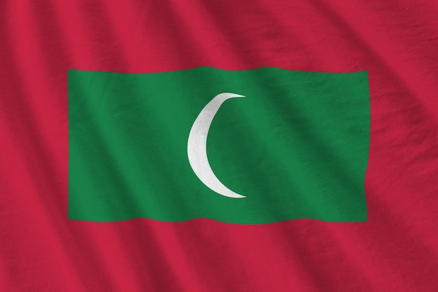 Maldives flag with big folds waving close up under the studio light indoors the official symbols and