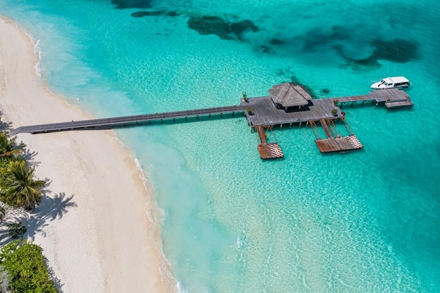 Maldives paradise island shore. Tropical aerial landscape, seascape bay long pier, water villas