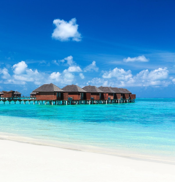 Maldives water bungalows resort at islands beach Indian Ocean Maldives Beautiful sea landscape luxury resort and sky Beach under wonderful sky