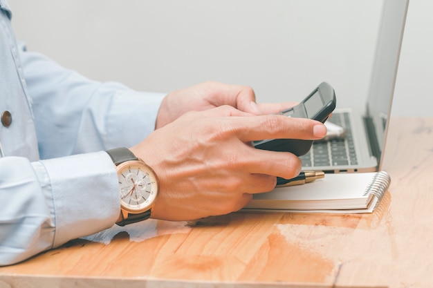 Male accountant making calculations,reviewing data in financial charts and graphs  at work place. Business financial  concept.