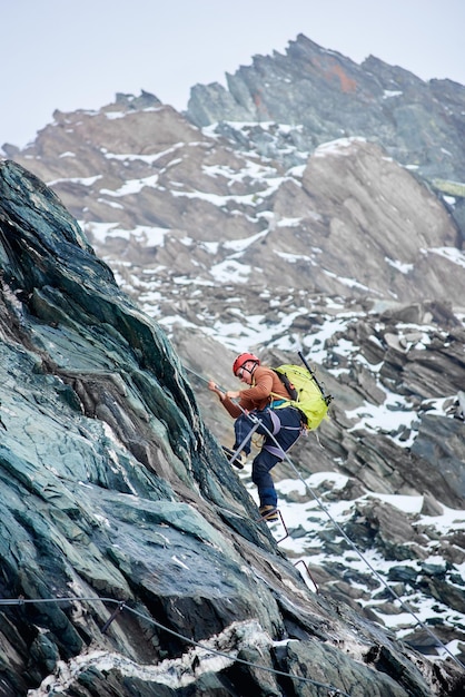 Male alpinist climbing mountain in Austria