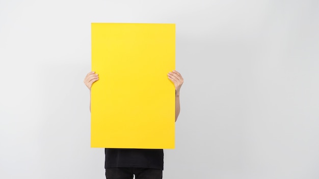 Male asian hand is holding the blank yellow color paper