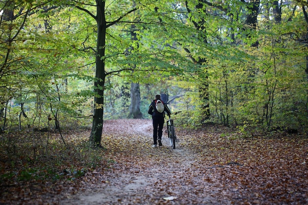 Male bicyclist in autumn park