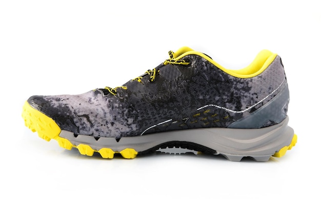 Male black and yellow sport sneakers with grey sole isolated on a white backgrond