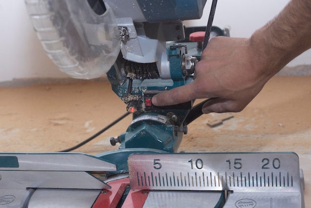 male builder carpenter sawing a circular saw