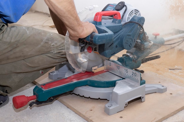 male builder carpenter sawing a circular saw