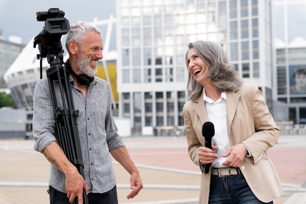 Male cameraman talking to a female journalist