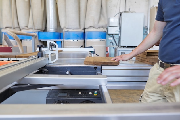 Male carpenter making wooden designer furniture for an individual private order