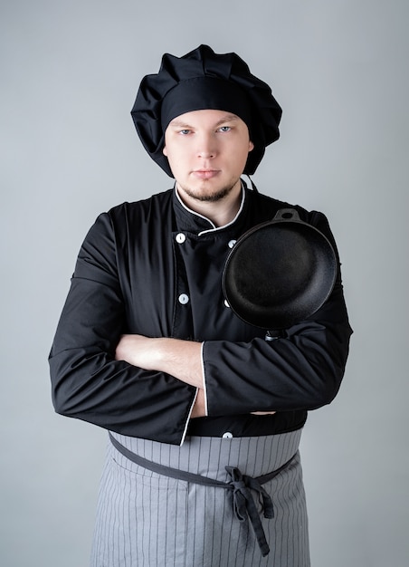 Male chef in a dark cooking uniform