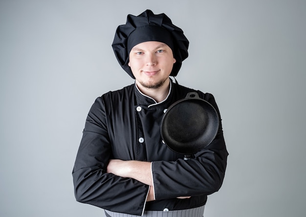 Male chef in a dark cooking uniform