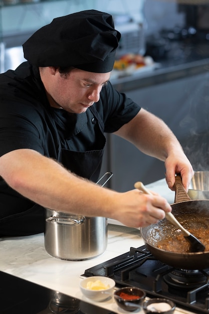 Male chef in kitchen cooking