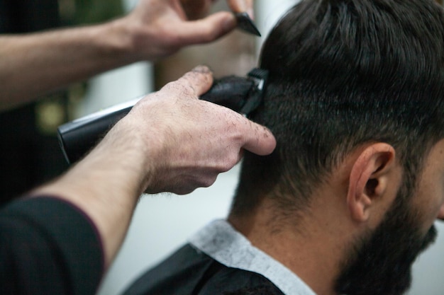 Male client getting haircut by hairdresser