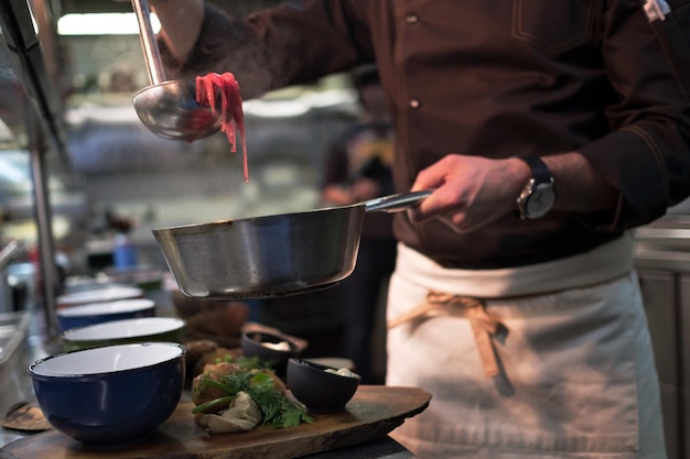 Male cook serve delicious meal in restaurant