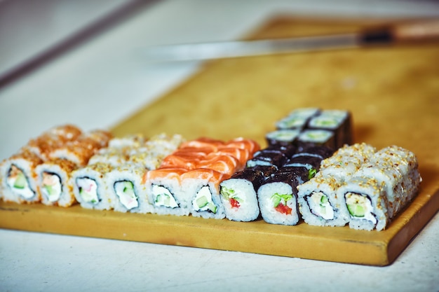 Male cooks preparing sushi in the restaurant kitchen.