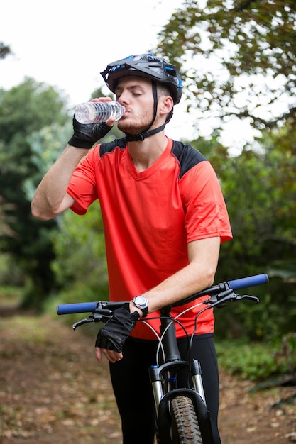 Male cyclist drinking water