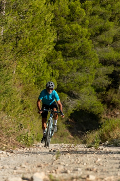 A male cyclist in a gravel road bicycle ride in the mountains of Costa Blanca Alicante Spain