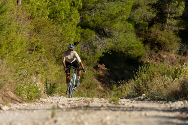 A male cyclist in a gravel road bicycle ride in the  mountains of Costa Blanca, Alicante, Spain