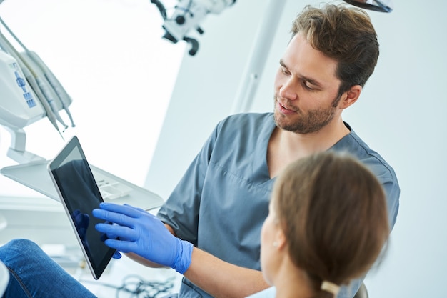 Male dentist and woman in dentist office